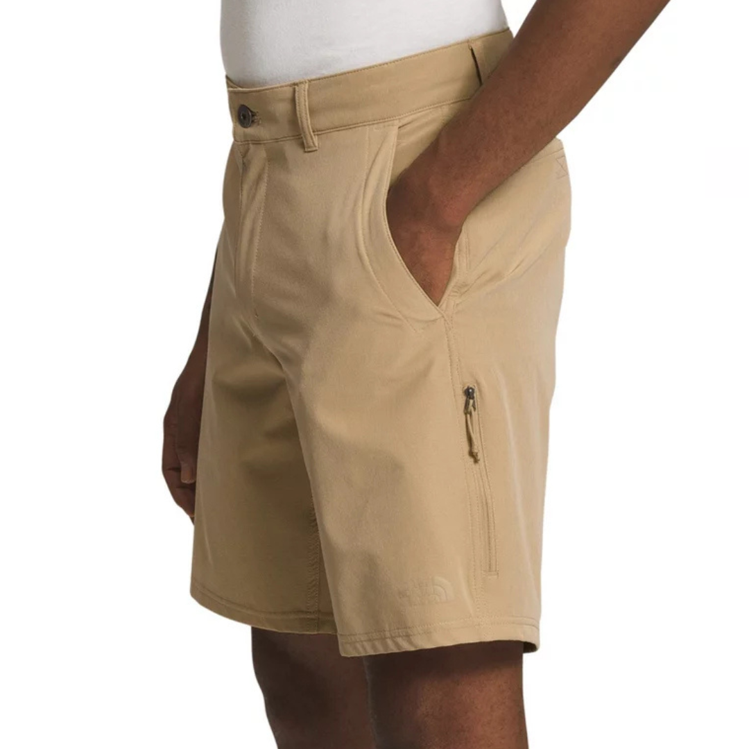 The North Face Rolling Sun Shorts are beige, featuring a button closure, belt loops, and front and side pockets with a zipper.