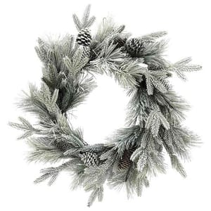 A frosted Christmas wreath featuring pine branches and cones, creating a winter-themed decoration.