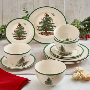 12-piece Spode Christmas Dinnerware Set featuring a festive Christmas tree design with a green rim, including plates, bowls, and saucers.