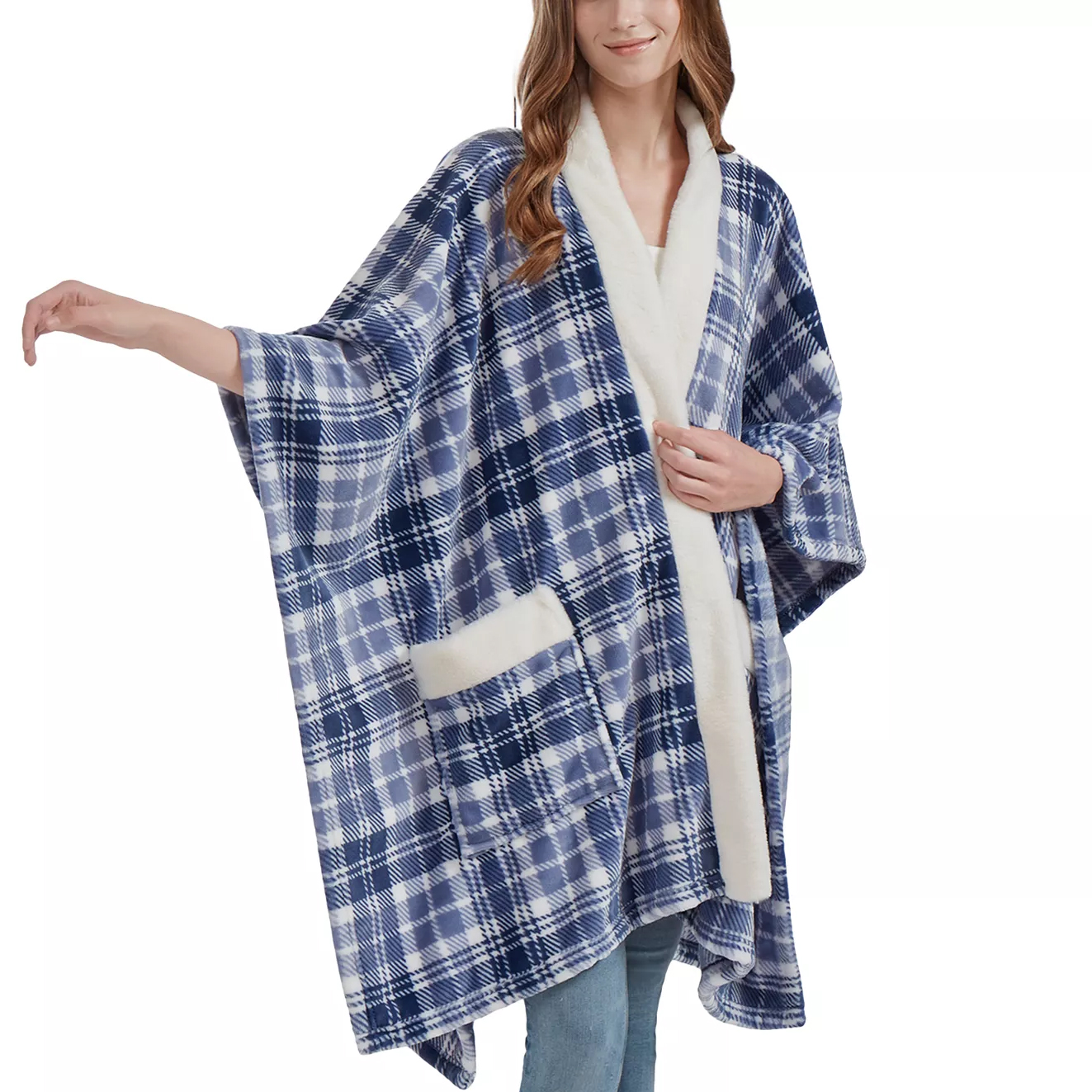A person wearing a blue and white plaid fleece poncho with a white fuzzy trim and pocket, paired with jeans.