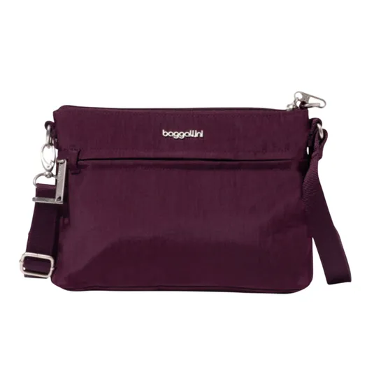 A purple Baggallini crossbody bag with a zippered main compartment, adjustable strap, and silver-tone hardware.