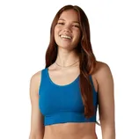 A woman is wearing a blue sports bra and matching shorts.