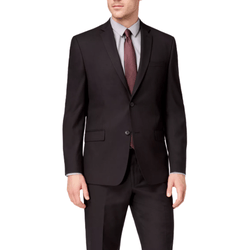 A man is wearing a formal black suit with a gray shirt and a dark red tie. The suit features a two-buttoned jacket and matching trousers.