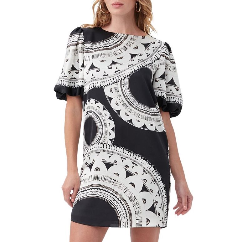 The Trina Turk Luv Dress features a black and white geometric pattern with half sleeves and a loose, above-the-knee fit. It includes a round neckline and puffed sleeves for a stylish look.