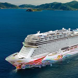 A large, modern cruise ship with colorful designs sails through a scenic sea with mountainous islands in the background.