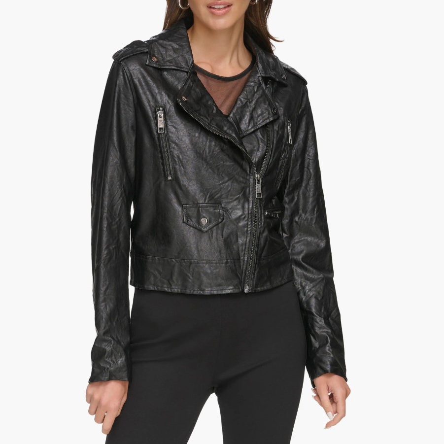 A woman is wearing a black washed faux-leather moto jacket with asymmetrical zipper closure and multiple zippered pockets.