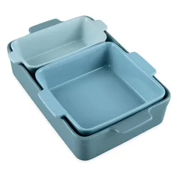 A set of three nested baking dishes in varying shades of blue, featuring rectangular and square shapes with built-in handles.