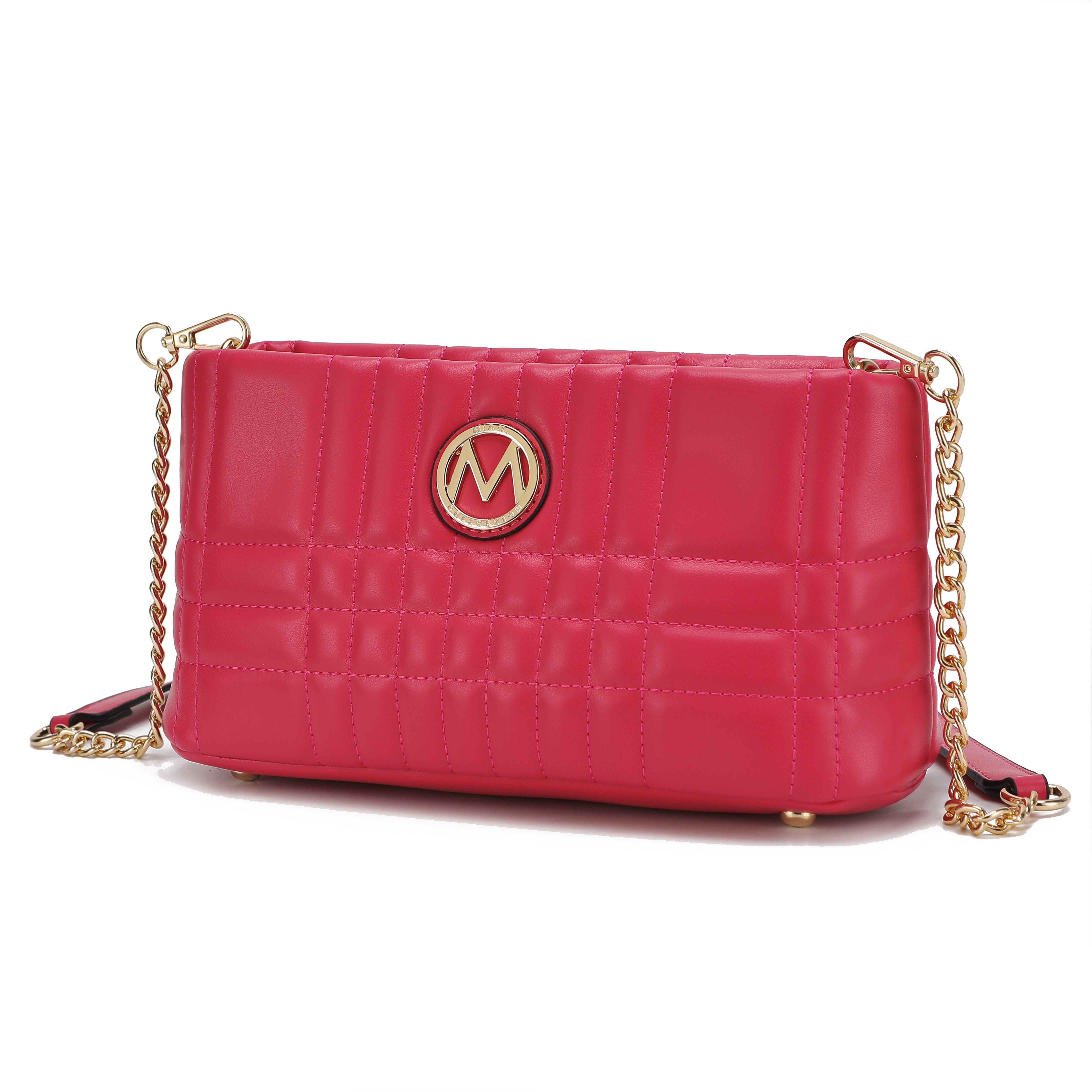 A quilted pink handbag with a gold chain strap and a circular emblem featuring the letter \“M\“.