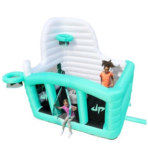 An inflatable bounce house with basketball hoops and a slide, featuring a turquoise and white color scheme. It's designed for children's play, with spaces to jump and shoot hoops.