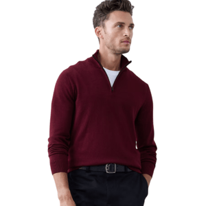 A person is wearing a burgundy quarter-zip sweater, a white undershirt, and black trousers with a belt. The outfit is simple and stylish against a plain background.