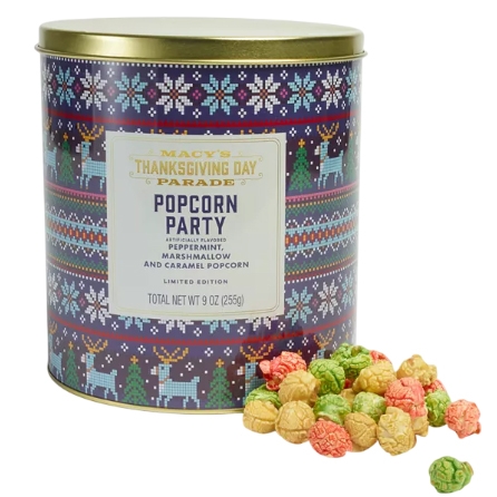 Macy's Thanksgiving Day Parade Popcorn Party tin contains peppermint, marshmallow, and caramel-flavored popcorn. The tin features a festive holiday design with reindeer and snowflake patterns, and the total weight is 9 oz (255g).