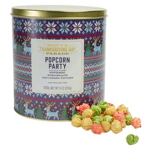 Macy's Thanksgiving Day Parade Popcorn Party tin contains peppermint, marshmallow, and caramel-flavored popcorn. The tin features a festive holiday design with reindeer and snowflake patterns, and the total weight is 9 oz (255g).