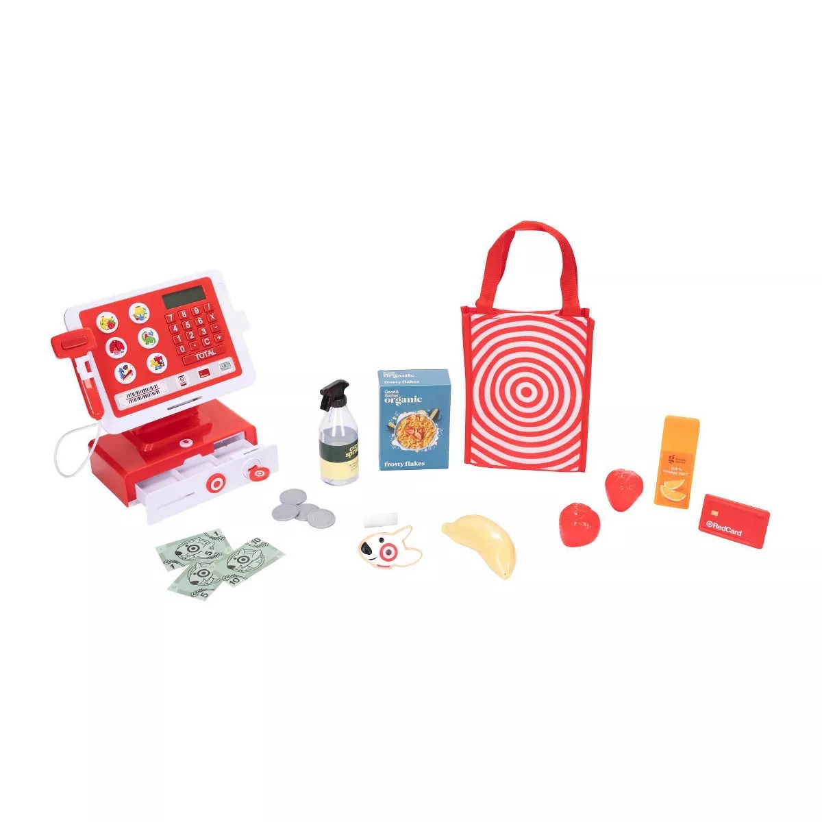 Toy cash register set with accessories including play money, coins, a scanner, a shopping bag with a bullseye design, faux cereal, fruit, a spray bottle, and an orange juice container.