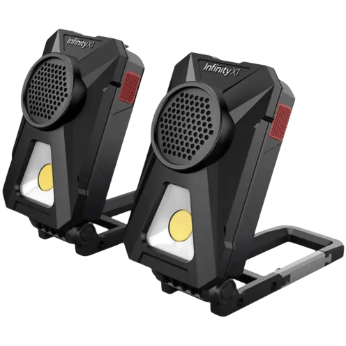 Two Infinity X1 portable LED work lights, each with a built-in speaker, featuring a foldable handle for easy positioning and carrying.