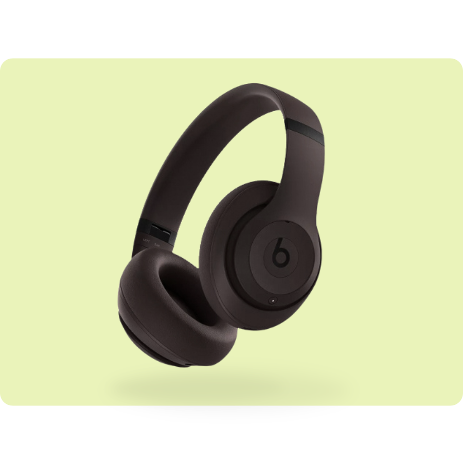 Dark brown over-ear wireless headphones with a prominent \“b\“ logo on the earcup against a light green background.