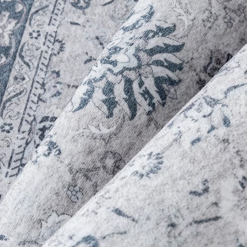 Fabric with a floral and abstract blue pattern on a light gray background.