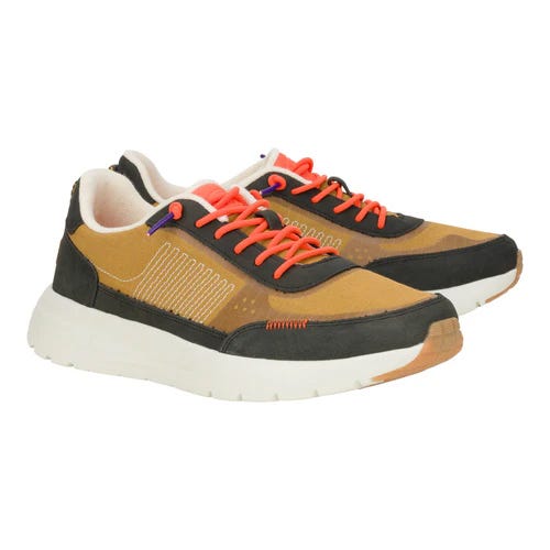 Hey Dude Sirocco Alta Hype Sneakers feature a mix of tan and black colors with vibrant orange laces, a cushioned white sole, and subtle purple accents, offering a lightweight and casual design.