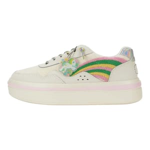 A white sneaker featuring a colorful rainbow design on the side with a decorative unicorn charm attached to the laces. The shoe includes iridescent accents and a platform sole with a pink stripe detail.