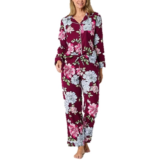 A two-piece Liz Claiborne pajama set featuring a floral pattern with a mix of white and pink flowers on a maroon background, finished with contrasting piping trim.