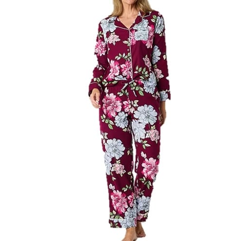 A two-piece Liz Claiborne pajama set featuring a floral pattern with a mix of white and pink flowers on a maroon background, finished with contrasting piping trim.