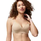 A woman wearing a beige, seamless bra with thin straps, designed for a smooth and comfortable fit.