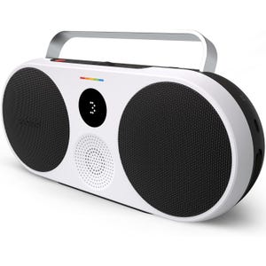 The Polaroid P3 Wireless Boombox features a retro design with two large speakers, a central display, and a carrying handle. The device is primarily white with black speaker grilles and includes a rainbow strip detail.