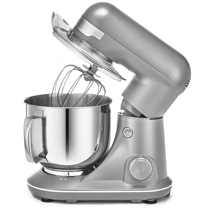 A metallic silver stand mixer with a stainless steel mixing bowl, featuring a tilt-head design and a wire whisk attachment. It has a speed control dial on the side.