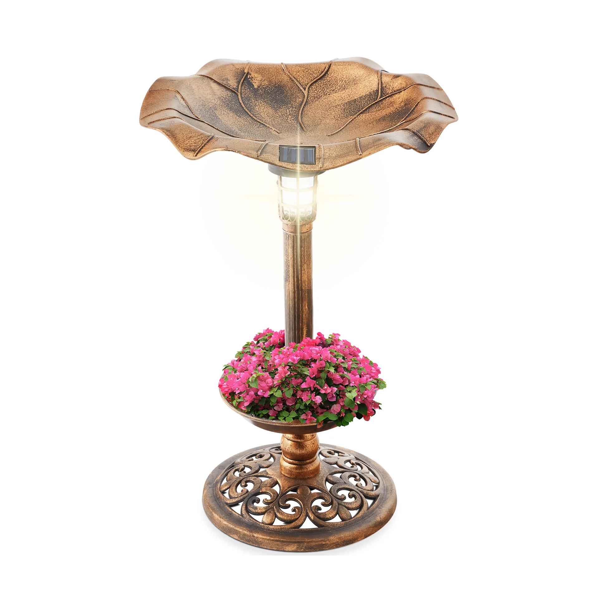 A bronze-colored birdbath with a solar light on top, featuring a design resembling a leaf. It includes a lower section filled with pink flowers and a decorative base.