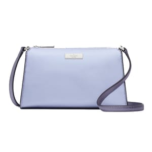 A light blue Kate Spade Kenzie Mini Crossbody bag with a long, adjustable strap, and the brand's logo on a metallic plate.