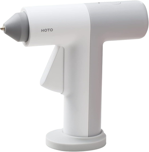 A white, handheld electric glue gun with a modern design, featuring a nozzle and trigger, branded with \“HOTO.\“