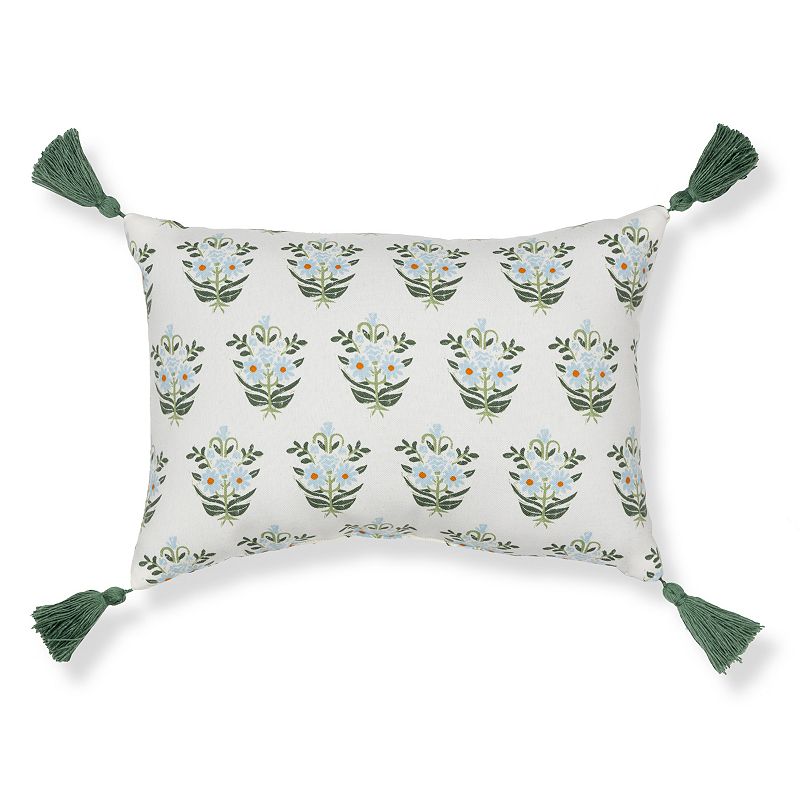 Rectangular throw pillow with a floral pattern and green tassels on each corner.
