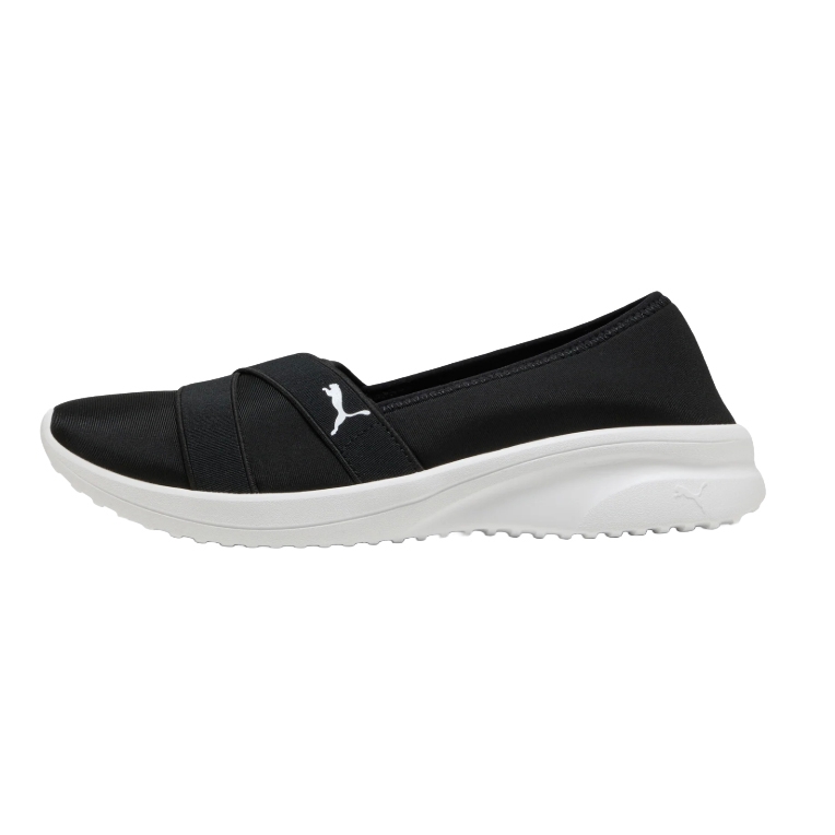 Puma Women's Slip-On Shoe features a black upper with a white sole and a white Puma logo. The design includes a crisscross strap for added style and comfort, suitable for casual wear.