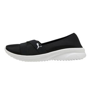 Puma Women's Slip-On Shoe features a black upper with a white sole and a white Puma logo. The design includes a crisscross strap for added style and comfort, suitable for casual wear.