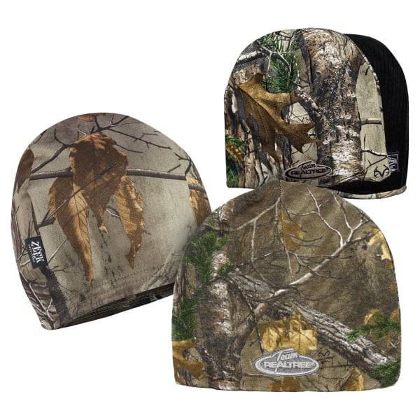 Three camo-print beanies featuring woodland patterns with branches and leaves, designed for outdoor and hunting activities.