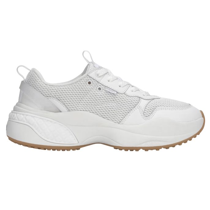 A white athletic sneaker features a mesh upper with leather overlays, a chunky sole with textured detailing, and a tan rubber outsole.