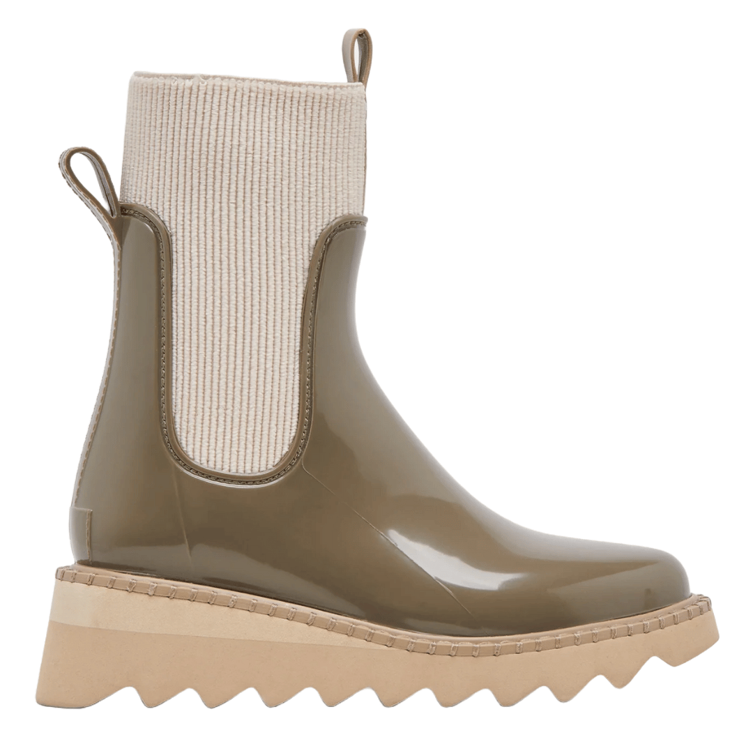Dolce Vita H20 Boots feature a glossy olive green finish, beige ribbed knit upper, pull tabs, and zigzagged beige rubber platform soles.