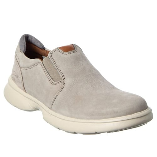 A beige slip-on shoe with a smooth leather upper, elastic side panels, and a thick, cushioned sole designed for comfort.