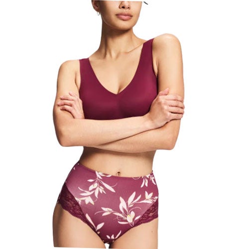 Woman wearing a burgundy bra and high-waisted floral panties with lace detailing.