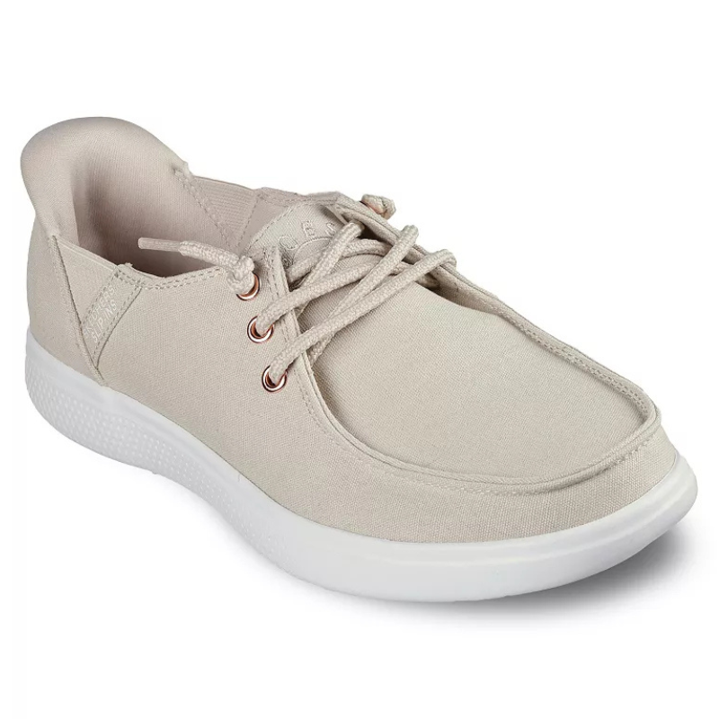 A light beige casual shoe with fabric upper, lace-up design, and contrasting white textured sole.