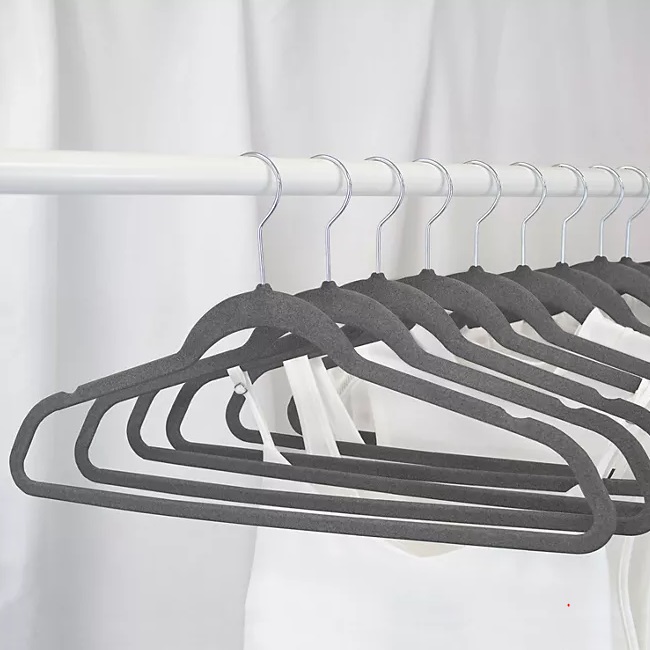Velvet-coated slim hangers on a closet rod.