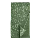 Green jacquard towel with a leaf pattern, featuring a folded corner to reveal a solid-colored underside.