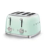 A mint green, retro-style SMEG four-slice toaster with dual controls and a chrome finish.
