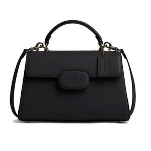 A black leather Coach purse featuring a top handle, adjustable shoulder strap, and the Coach New York logo on the front.