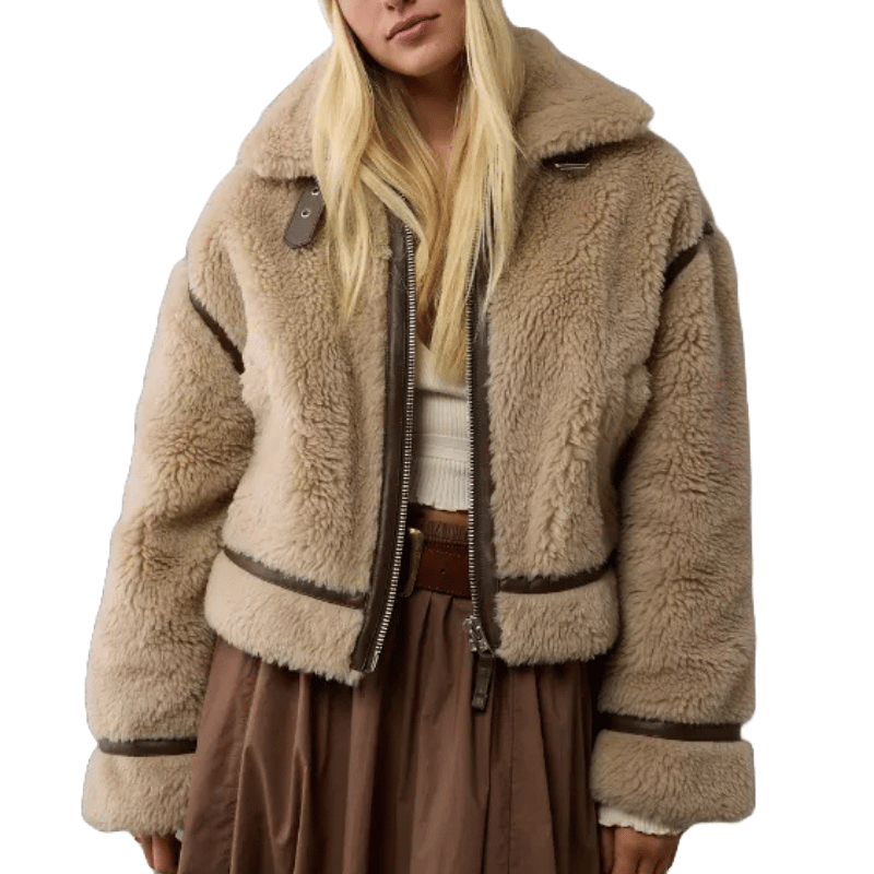 A tan teddy biker jacket with plush, fluffy texture features a wide collar, brown trim, and front zipper closure, offering a cozy and stylish appearance.