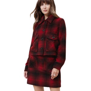 Red and black plaid jacket with button closure and two front pockets, featuring a collared neckline and long sleeves.