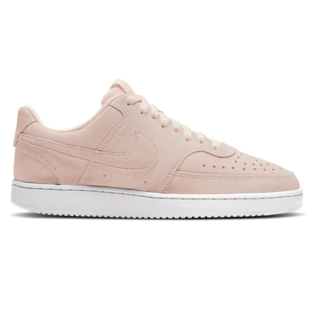 Pink suede Nike sneakers with a white sole, featuring a perforated toe box and signature Nike swoosh.