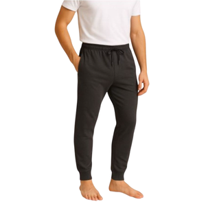 A person wearing black jogger pants with an elastic waistband and drawstring, paired with a white T-shirt.