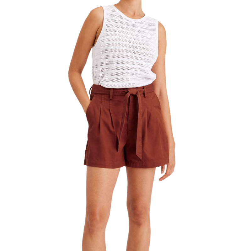 The Dockers Tie Front Short features a high-waisted design with a rust color, pleats, side pockets, and a self-tie belt, paired with a white sleeveless knit top.