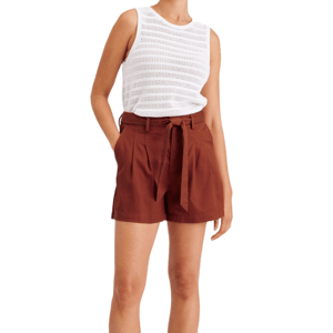 The Dockers Tie Front Short features a high-waisted design with a rust color, pleats, side pockets, and a self-tie belt, paired with a white sleeveless knit top.