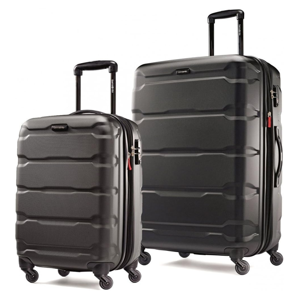 Two black hard-shell suitcases with telescopic handles and four spinner wheels each are displayed side by side, differing in size.
